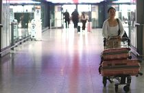 A passenger walks with her luggage through Heathrow Terminal 5 airport in London, Britain.