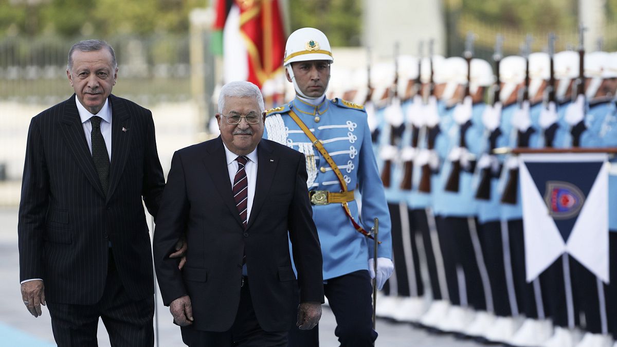 Turkey's President Recep Tayyip Erdogan and Palestinian President Mahmoud Abbas review a military honour guard during a welcome ceremony in Ankara, 23 August 2022