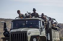 Ethiopian government soldiers ride in the back of a truck on a road near Agula, north of Mekele, in the Tigray region of northern Ethiopia