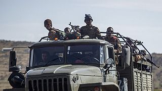 Ethiopian government soldiers ride in the back of a truck on a road near Agula, north of Mekele, in the Tigray region of northern Ethiopia