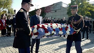 Emmanuel Macron lays a wreath at Bezons bridge near Paris, Oct. 16, 2021, the first French president to commemorate the brutal repression of an Oct 17, 1961 demonstration.