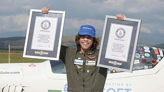 Mack Rutherford, a 17-year-old British-Belgian pilot holds his Guinness award plates after he landed in Sofia-West ariport, Aug. 24, 2022. 