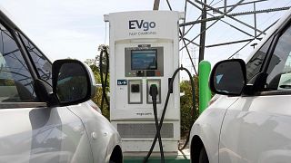 Electric cars are parked at a charging station in Sacramento, California.