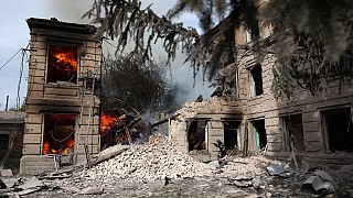 A Ukrainian firefighter extinguishes a blaze in a destroyed college building following an air strike on the town of Sloviansk, Donetsk region on August 26, 2022.