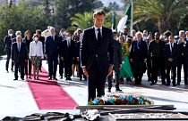 French President Emmanuel Macron pays his respect after laying a floral wreath at the Martyrs Monument in Algiers on August 25, 2022.