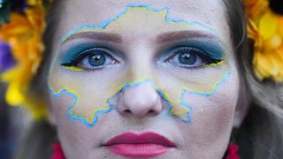 A woman made up with the outline of a map of Ukraine on her face takes part in a so called Freedom March demonstration, marking the Ukrainian Independence Day in Berlin