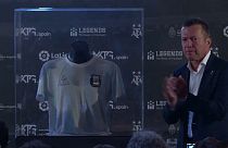 Lothar Matthäus, unveils Maradona's symbolic Number 10 shirt from the 1986 World Cup final.