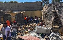 FILE - Residents sift through rubble from a destroyed building at the scene of an airstrike in Mekele, in the Tigray region of northern Ethiopia Thursday, Oct. 28, 2021
