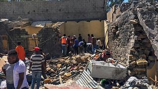 FILE - Residents sift through rubble from a destroyed building at the scene of an airstrike in Mekele, in the Tigray region of northern Ethiopia Thursday, Oct. 28, 2021