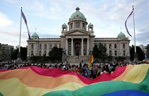 Participants carry large rainbow flag in front of the parliament building as they take part in the annual LGBT pride march in Belgrade, 19 September 2021
