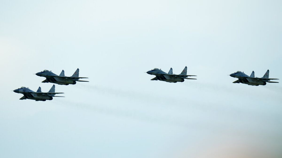 Slovak Air Force MiG-29s fly over an airport during an airshow in Malacky, Slovakia, Saturday, Aug. 27, 2022