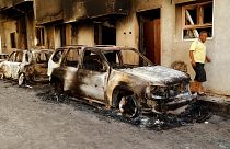 The remains of a car burned during clashes stands in a street in the Libyan capital of Tripoli, Sunday, August 28 2022.
