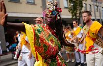 Performers dance during the children's parade on Family Day at the Notting Hill Carnival in London.