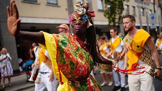 Performers dance during the children's parade on Family Day at the Notting Hill Carnival in London.