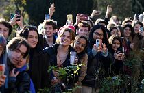 Students try to get a view of Britain's Prince Charles during his visit to Homerton College at the University of Cambridge