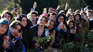 Students try to get a view of Britain's Prince Charles during his visit to Homerton College at the University of Cambridge