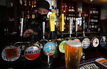 A barman draughts beer in the Black Lion pub in Hammersmith in London