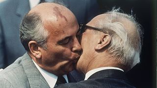 Soviet Communist Party leader Mikhail Gorbachev and East Germany's state and Communist party leader Erich Honecker exchange kisses in Berlin, 27 May 1987