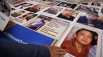FILE: Members of Muslim Uyghur minority present pictures of their relatives detained in China during a press conference in Istanbul, on May 10, 2022.