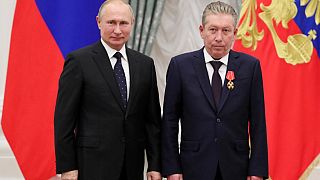 Ravil Maganov (R) pose for a photo during an awarding ceremony at the Kremlin in Moscow on November 21, 2019.