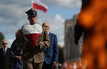A Polish soldier holds a wreath while attending a ceremony marking national observances of the anniversary of World War II in Warsaw, Poland, Sept. 1, 2022.