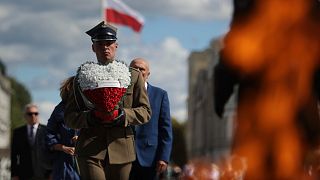 A Polish soldier holds a wreath while attending a ceremony marking national observances of the anniversary of World War II in Warsaw, Poland, Sept. 1, 2022.