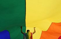 A participant holds up a large rainbow flag during the annual LGBT pride march in Belgrade, 18 September 2021