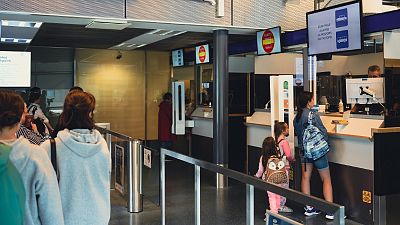 Russian tourists have their passport checked on July 28, 2022 at the Nuijamaa border crossing, Finland.