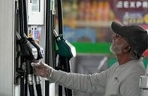 FILE - A driver looks at the petrol pump at a petrol station in London, Thursday, June 9, 2022.