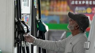 FILE - A driver looks at the petrol pump at a petrol station in London, Thursday, June 9, 2022. 