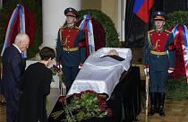 People stand by the coffin of former Soviet leader Mikhail Gorbachev inside the Pillar Hall of the House of the Unions during a farewell ceremony in Moscow, 3 September 2022
