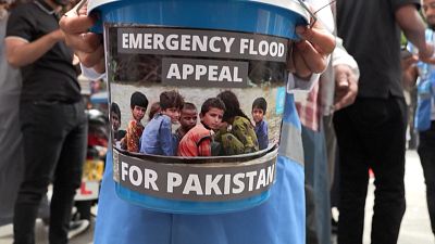 Boy holding bucket to collect funds