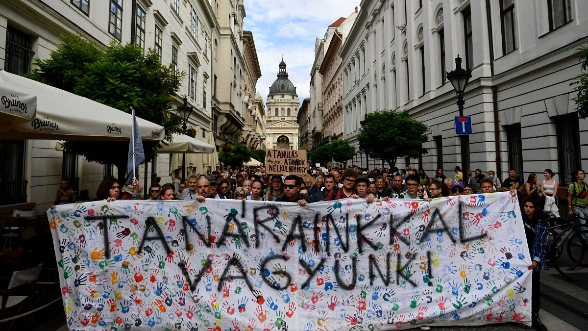 Students hold a banner reading "we stand by our teacher" during a protest in solidarity with their teachers in Budapest.