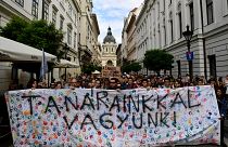 Students hold a banner reading "we stand by our teacher" during a protest in solidarity with their teachers in Budapest.