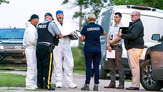 Investigators gather in front of the scene of a stabbing in Weldon, Saskatchewan, Sunday, Sept. 4, 2022.