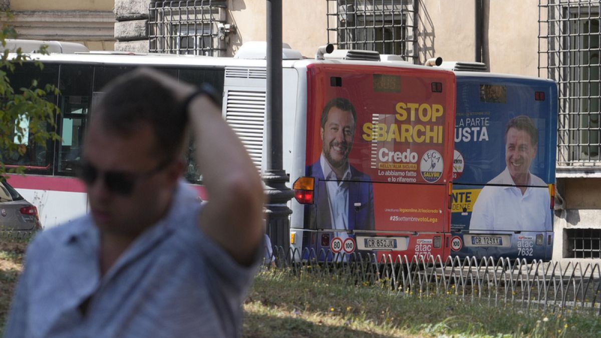 The electoral posters of the Northern League (left) and the Five Star Movement (right) on buses in Rome, Italy, on 1 September 2022.