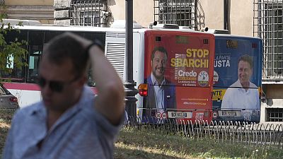 The electoral posters of the Northern League (left) and the Five Star Movement (right) on buses in Rome, Italy, on 1 September 2022.
