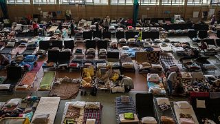Ukrainian refugees rest inside an indoor sports hall in the Polish border village of Medyka.