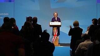 People applaud British lawmaker Liz Truss after winning the Conservative Party leadership contest