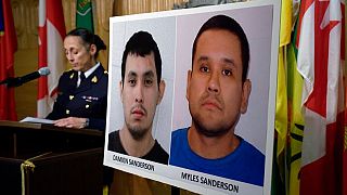 Assistant Commissioner Rhonda Blackmore speaks next to images of Damien Sanderson and Myles Sanderson during a press conference in Regina, Saskatchewan. Sept 4, 2022.