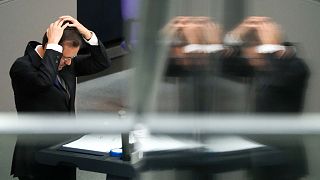 Israeli President Isaac Herzog adjusts a skullcap as he delivers a speech at the German parliament Bundestag at the Reichstag building in Berlin, Germany, Tuesday, Sept. 6, 20