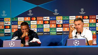 PSG's Kylian Mbappe, left, and PSG's head coach Christophe Galtier, give a press conference at the Parc des Princes stadium, in Paris.