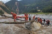Rescuers transfer survivors across a river in Sichuan Province following the earthquake.