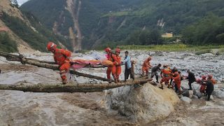 Rescuers transfer survivors across a river in Sichuan Province following the earthquake.