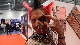 Photo shows Anderson Garcia Rodriguez posing at the Big London Tattoo show
