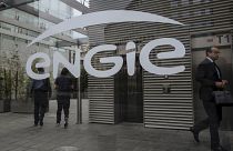 People walk in the lobby of the Engie headquarters, a group dealing with energy and services, in La Defense business district in Paris, Friday, Sept.2, 2022
