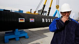 A Russian construction worker smokes in Portovaya Bay, Russia, on April 9, 2010, during a ceremony marking the start of Nord Stream pipeline construction. 