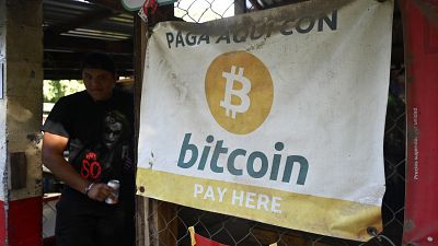 A sign promoting Bitcoin transactions is seen in a small shop in El Zonte beach, El Salvador, on of the places where the use of bitcoin has been most promoted, on August 2022