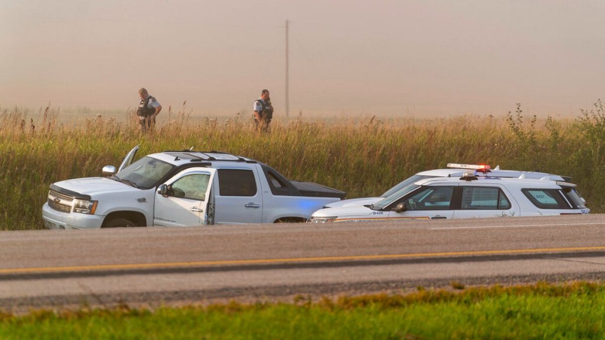 Police and investigators gather at the scene where a stabbing suspect was caught in Saskatchewan on Wednesday, Sept. 7, 2022. 