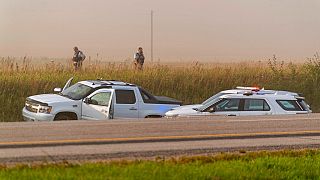 Police and investigators gather at the scene where a stabbing suspect was caught in Saskatchewan on Wednesday, Sept. 7, 2022.